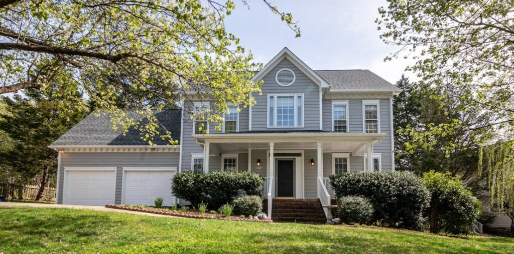 A neighborhood home with a roof installed by roofing companies in Durham NC.